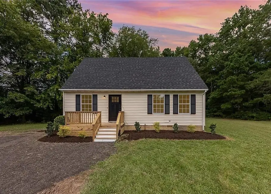 Small home with new siding, shutters and a pressure-treated entry deck with steps