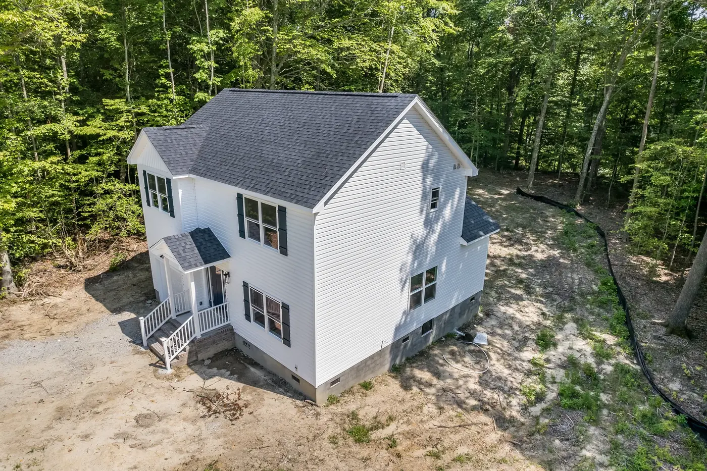 Aerial view of a Hampton Roads home with new siding, exterior stairs and a rear deck