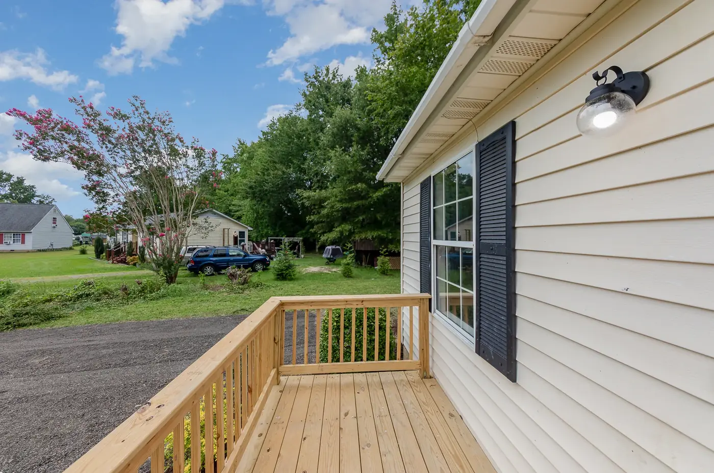New siding, trim and a pressure-treated deck along the side of a home