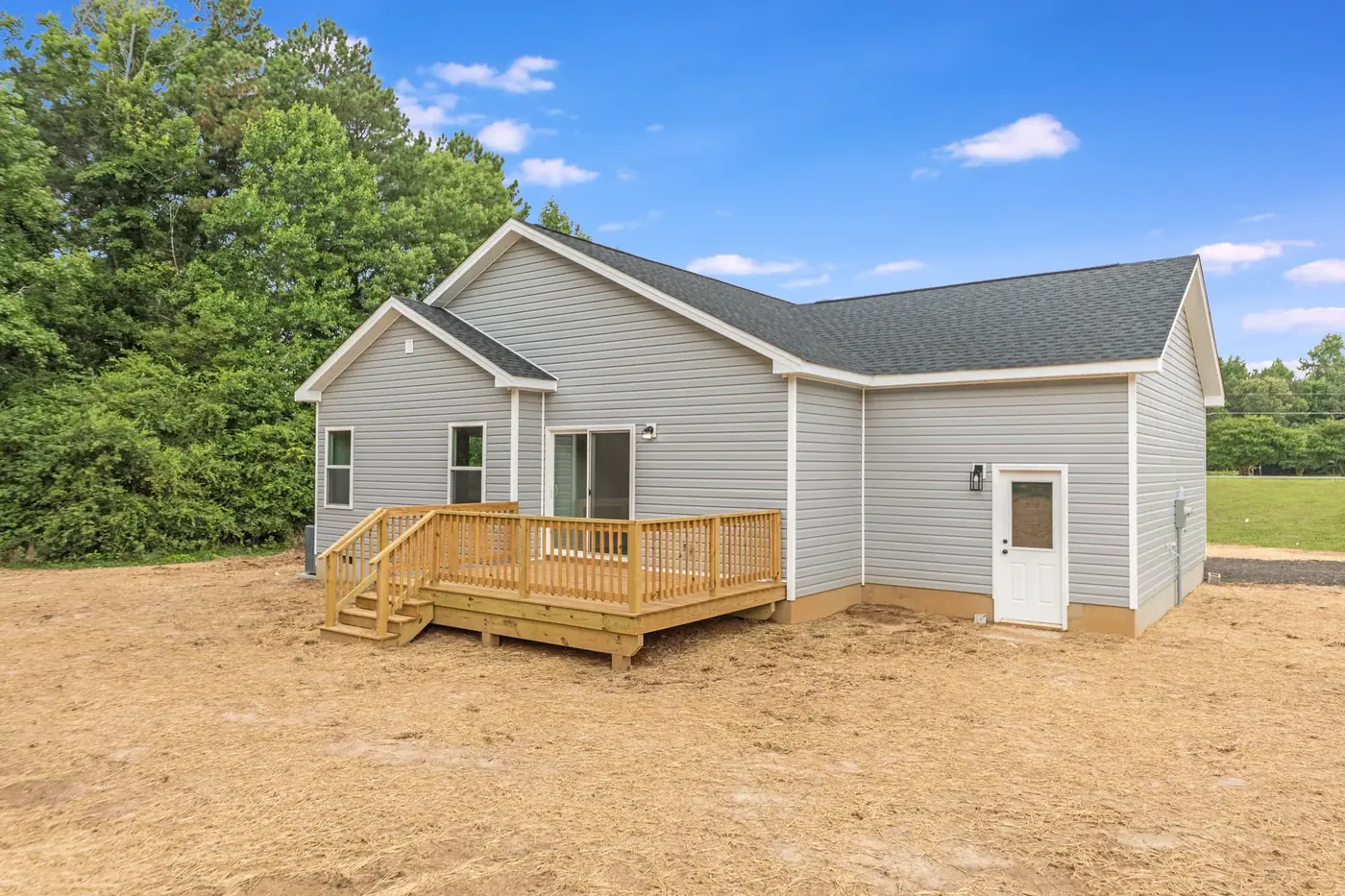 Completed home with fresh siding and a new timber deck with steps and railings