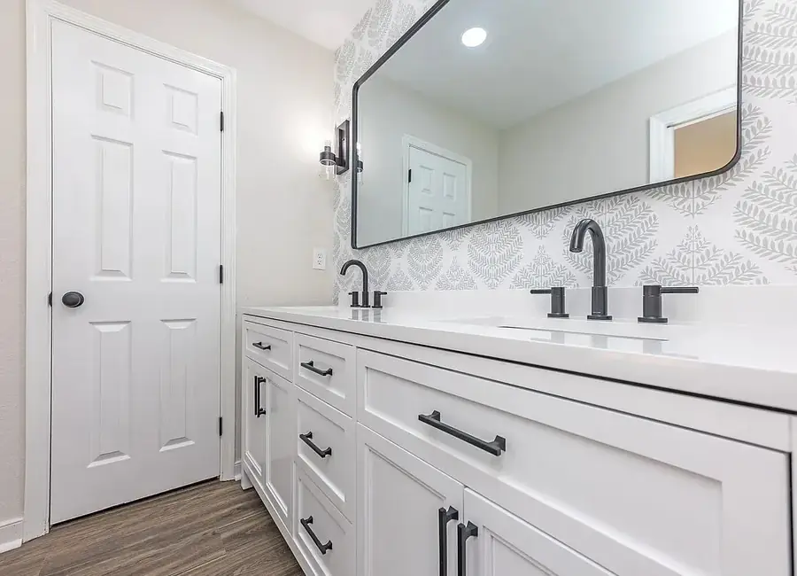 Renovated guest bathroom with vanity, quartz top and tiled floor