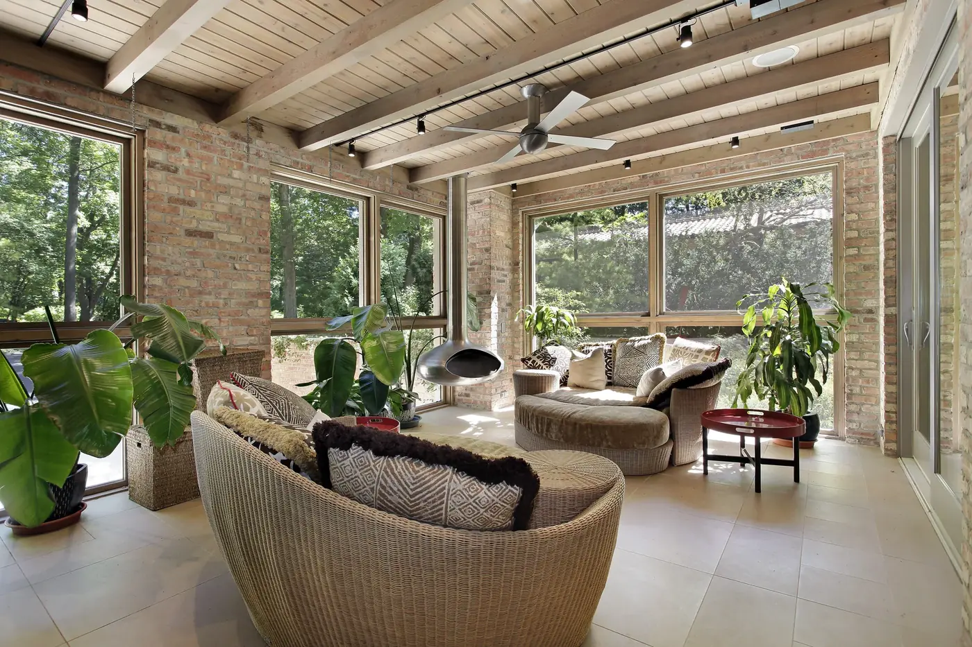 Sunlit room with exposed brick and a wood-slat ceiling, used as an atmospheric background image