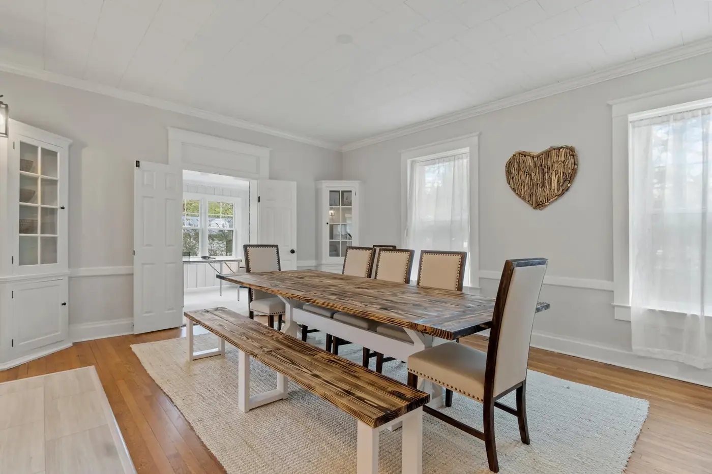 Dining and living area after a whole-home renovation with new flooring and trim