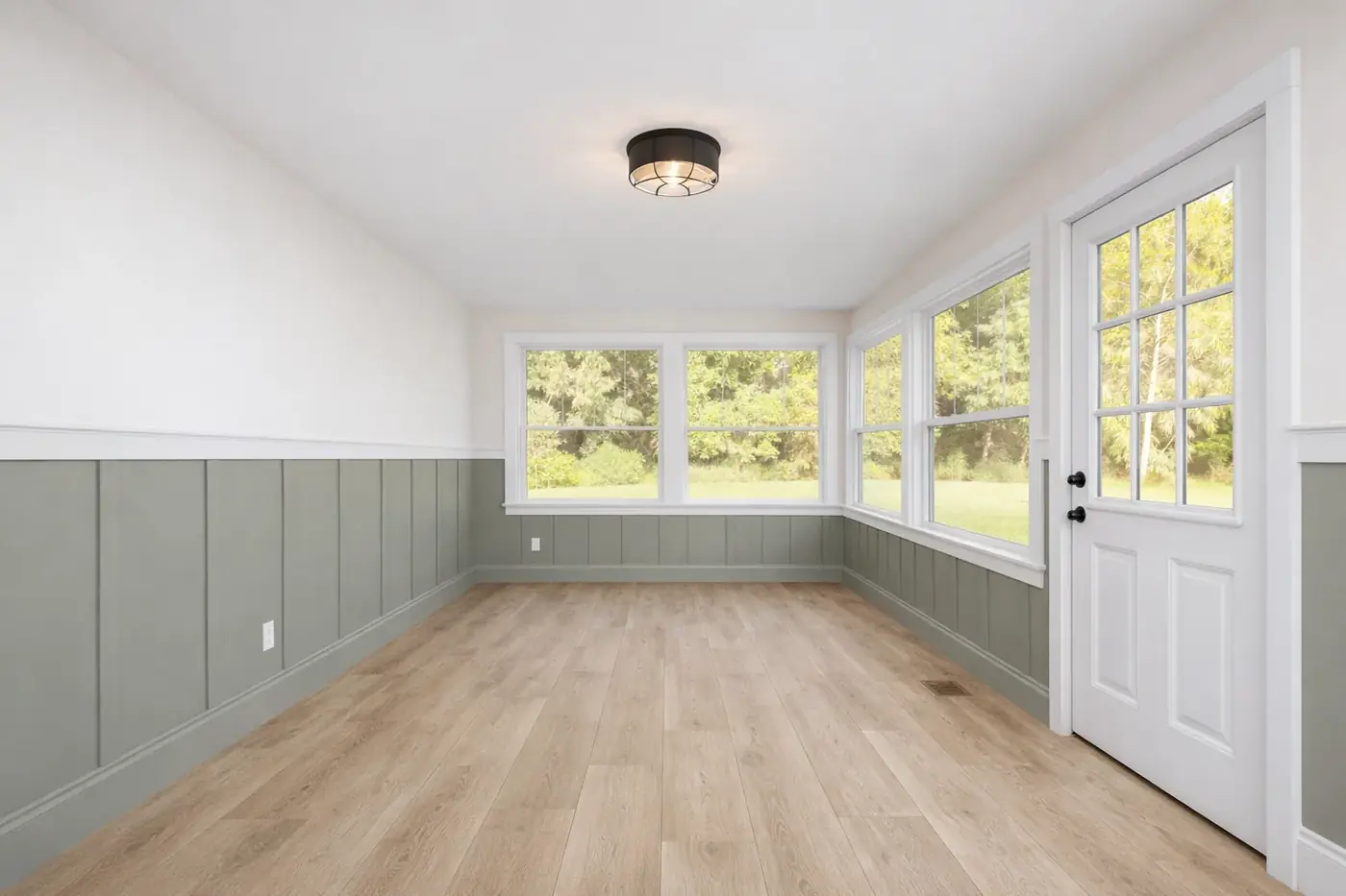 Bonus room with painted wainscoting and new plank flooring