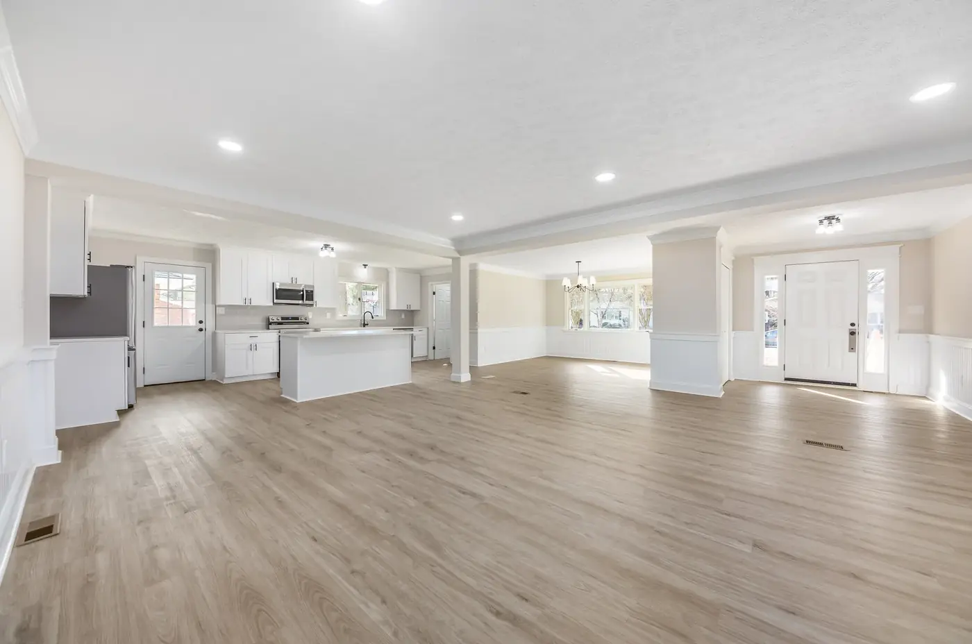 Open-plan kitchen and living space with new flooring throughout