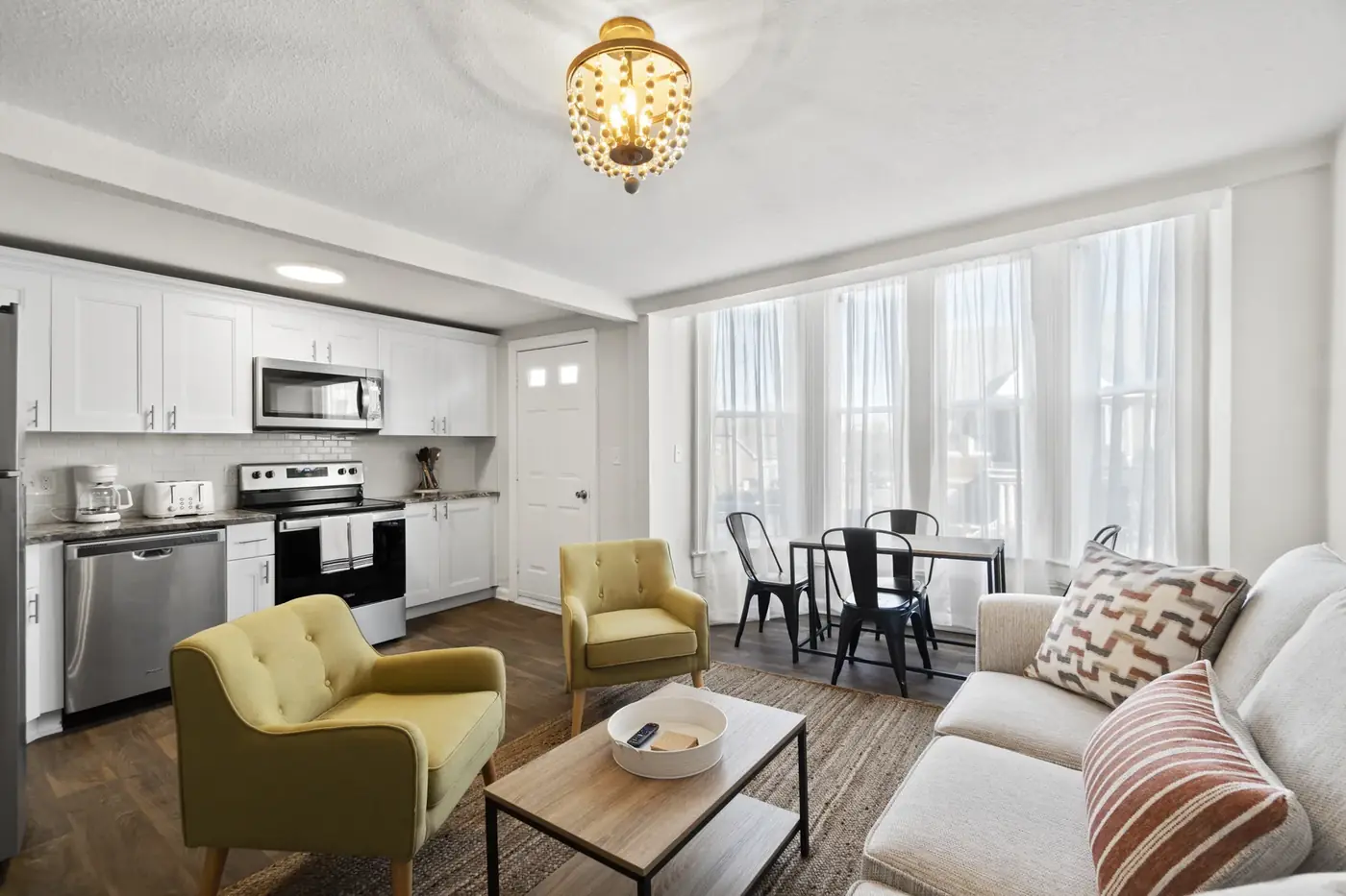 Living and dining rooms with new paint, lighting and flooring