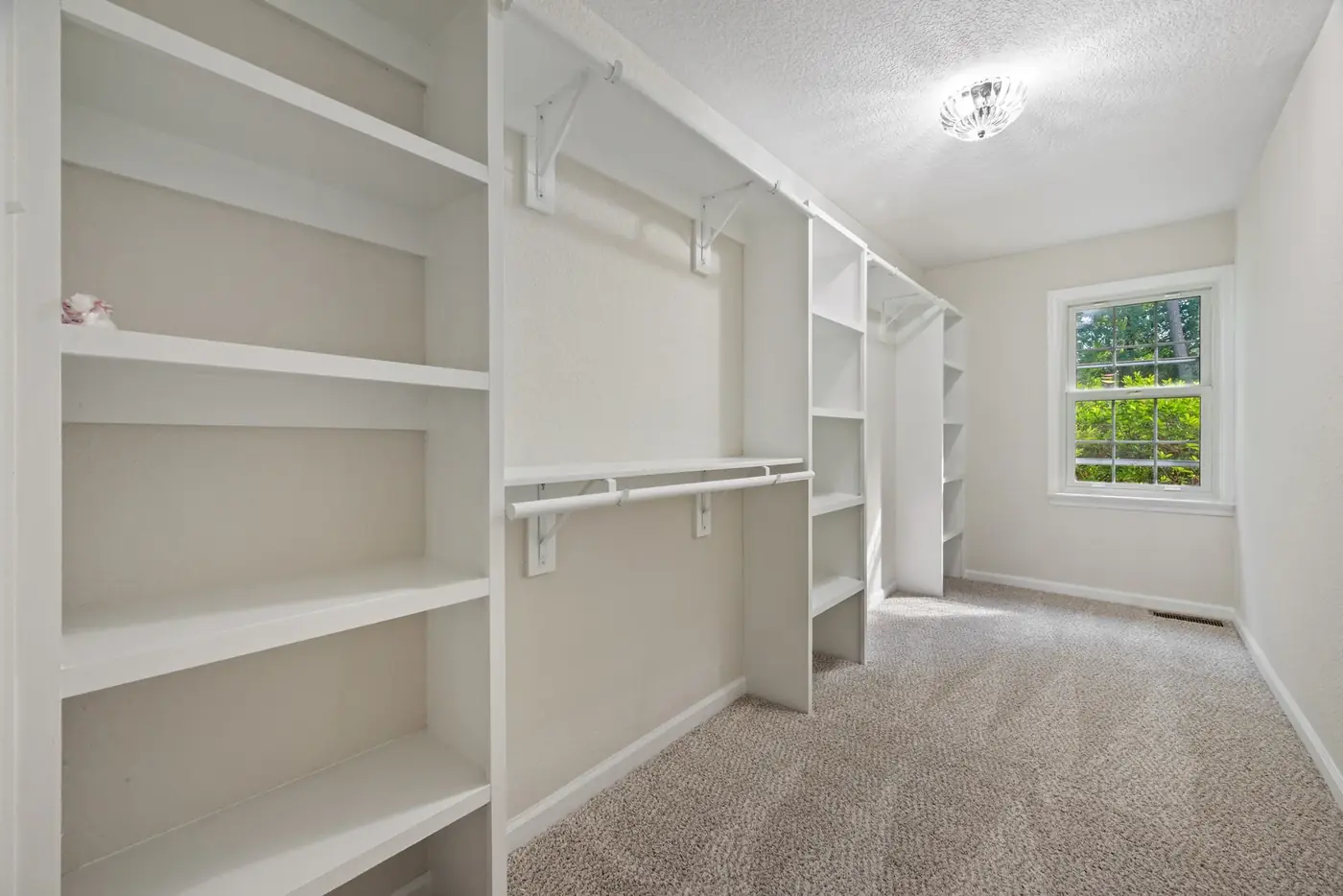 Interior of a home mid-remodel with new trim, shelving and fresh paint