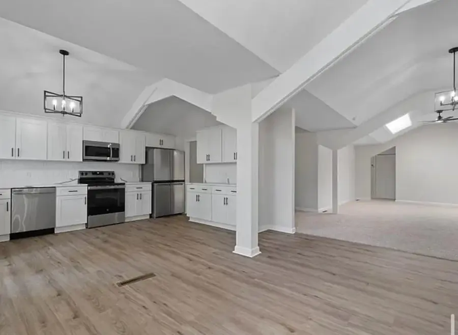 Empty room prepared for finishes with new flooring and appliances set