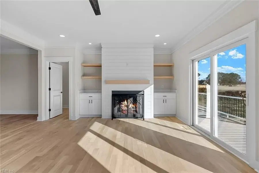 Living room with fireplace, new flooring and fresh trim