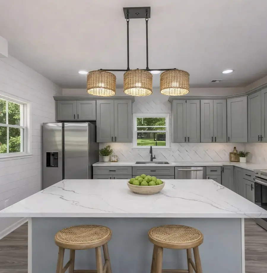 Compact kitchen with grey cabinetry, quartz counters and stainless appliances